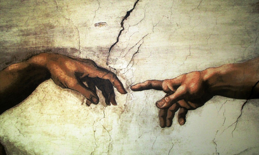A Michelangelo painting depicting two outstretched arms, symbolising the similarities yet differences between Life Insurance and Critical Illness