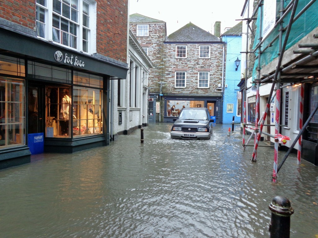 Flood water in Fowey causing flooding to shops and offices - a reason to have great Office and Premises Insurance